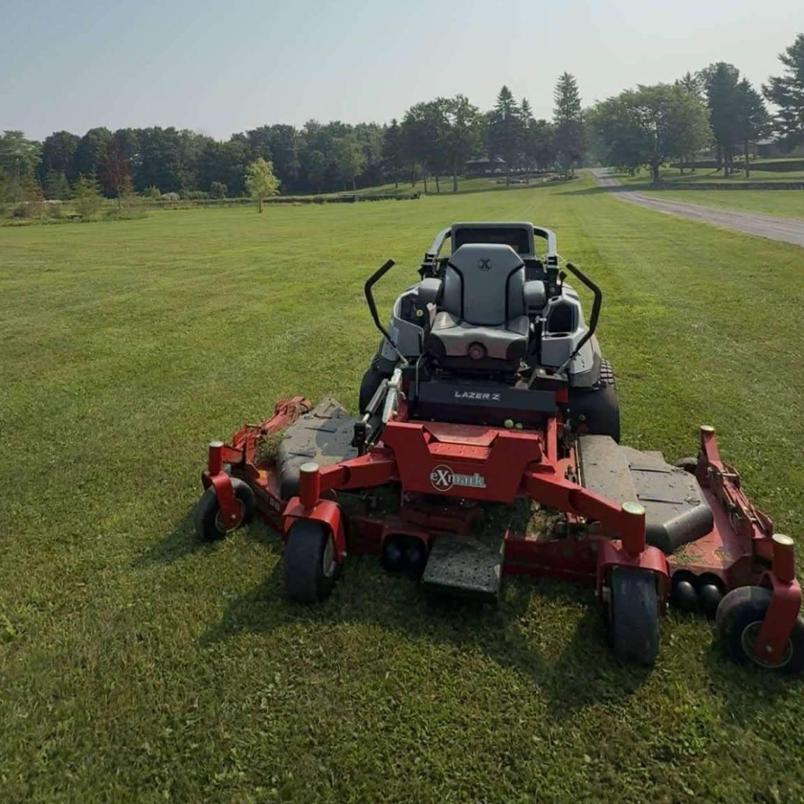 Red mower on a large field