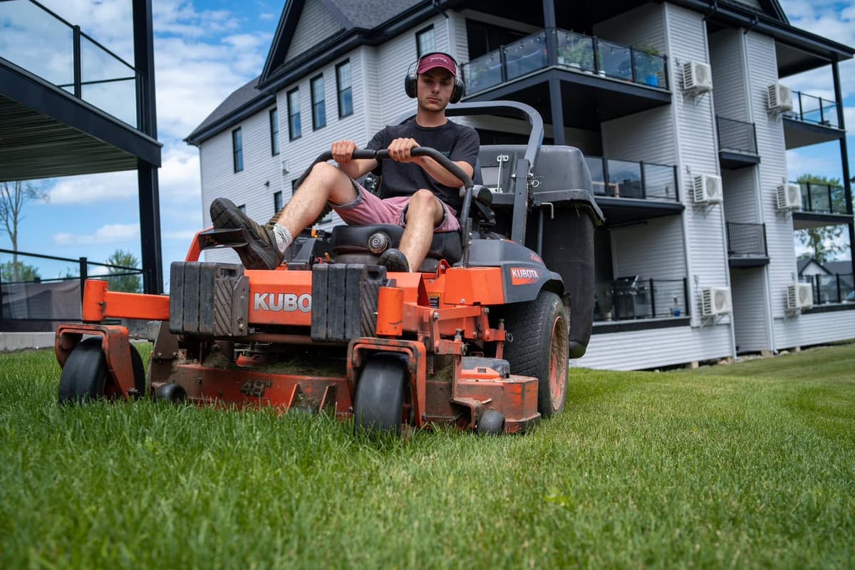 Gazon Charbonneau crew member on a ride-on mower