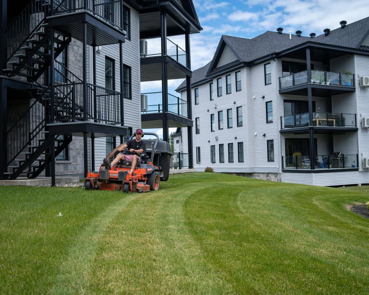 Mowing a commercial property in front of apartment buildings