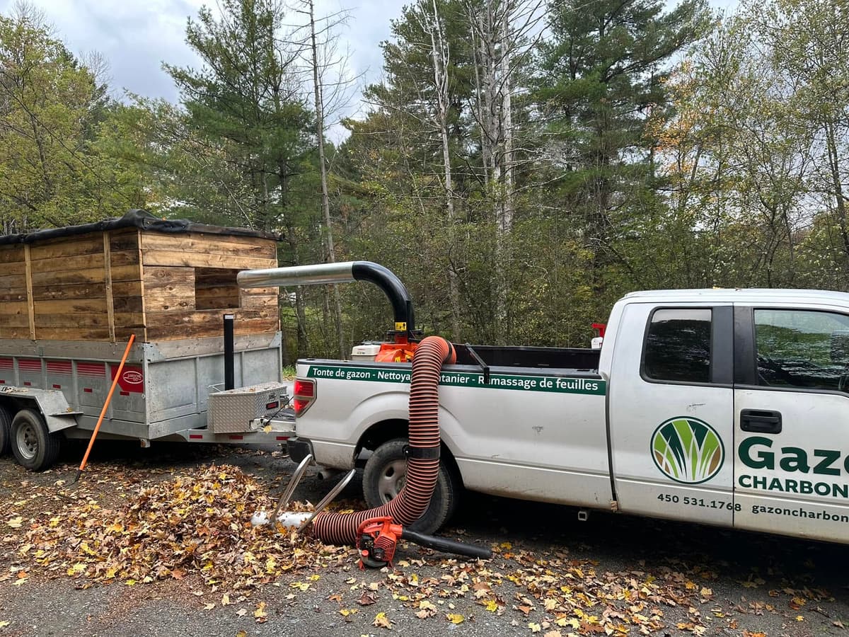 Gazon Charbonneau truck vacuuming fallen leaves